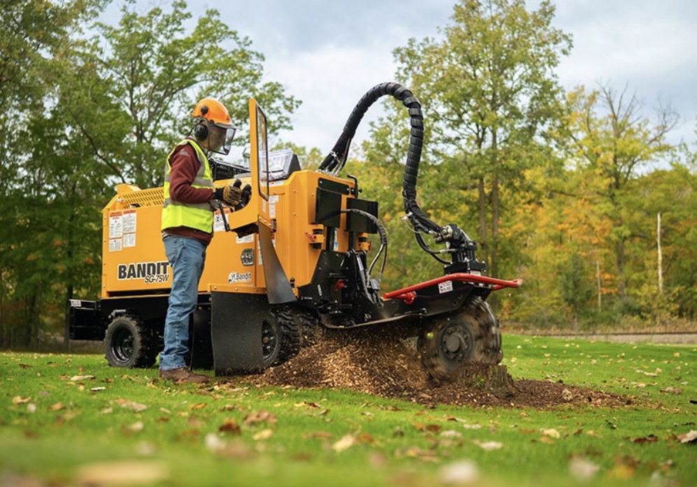 Bandit stump grinder cutting a stump in an open Nebraska yard